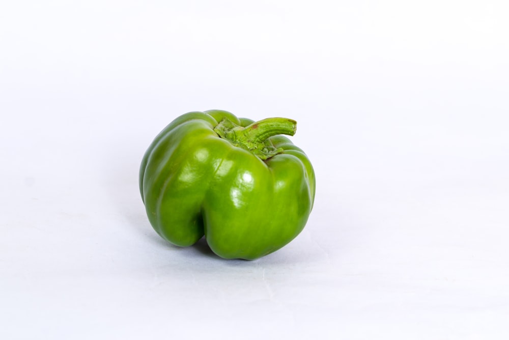 green bell pepper on white surface