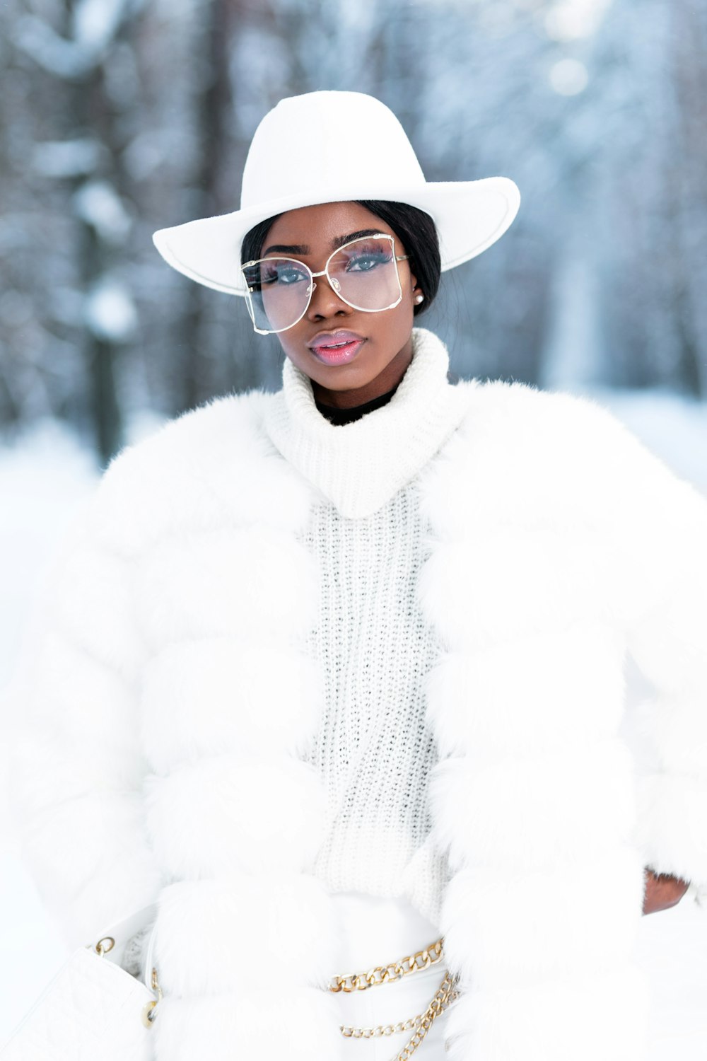 woman in white fur coat wearing black framed eyeglasses