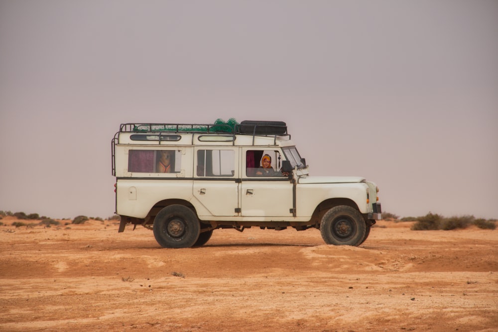 white suv on brown sand during daytime