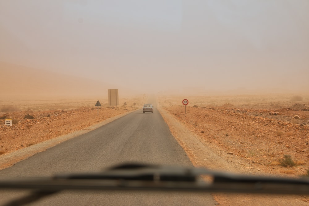 brown sand road during daytime