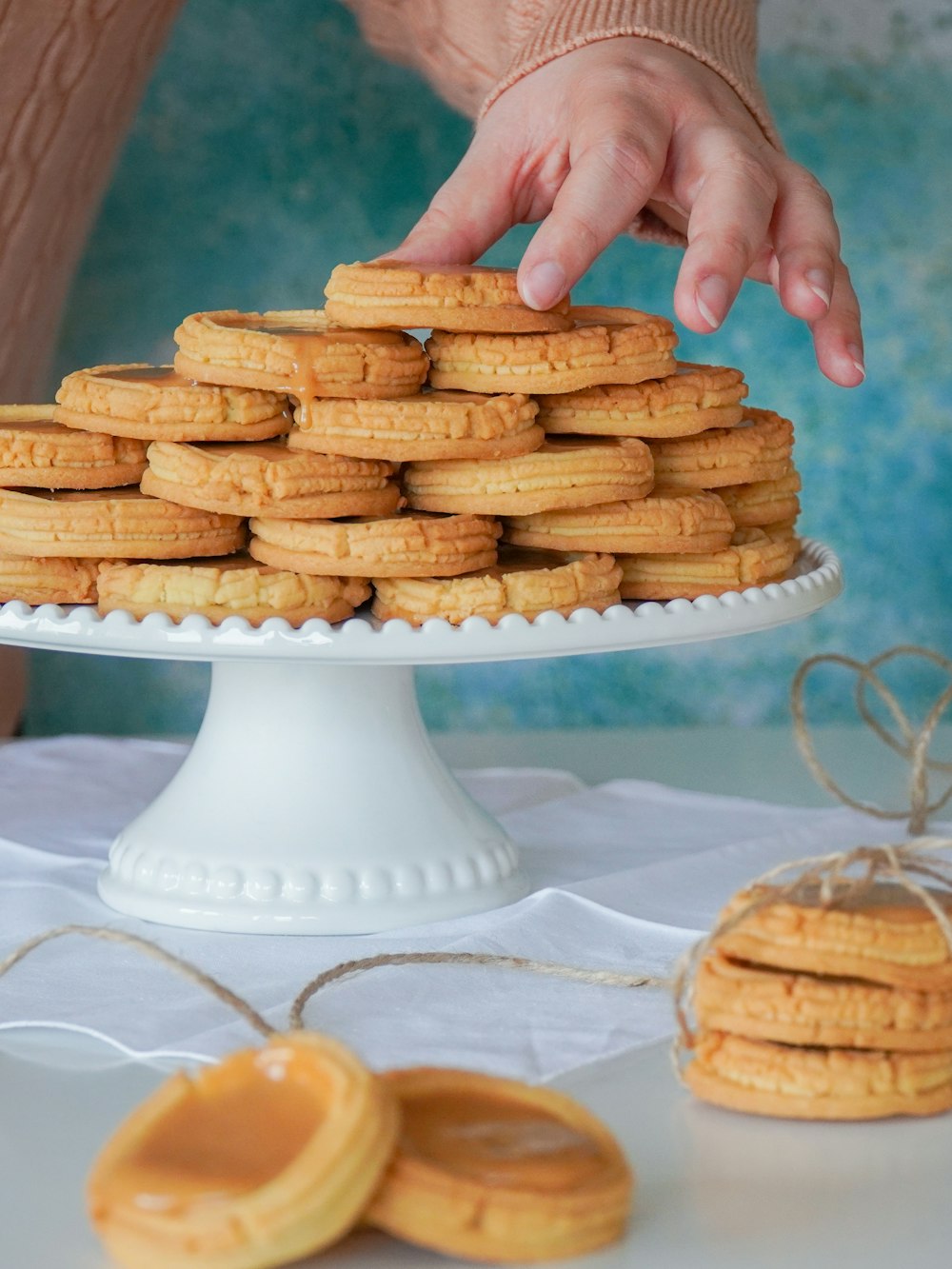 person holding white and brown cookies