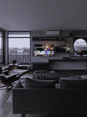 A sleek, minimalist living room featuring Italian-style furniture with marble accents and premium leather upholstery.