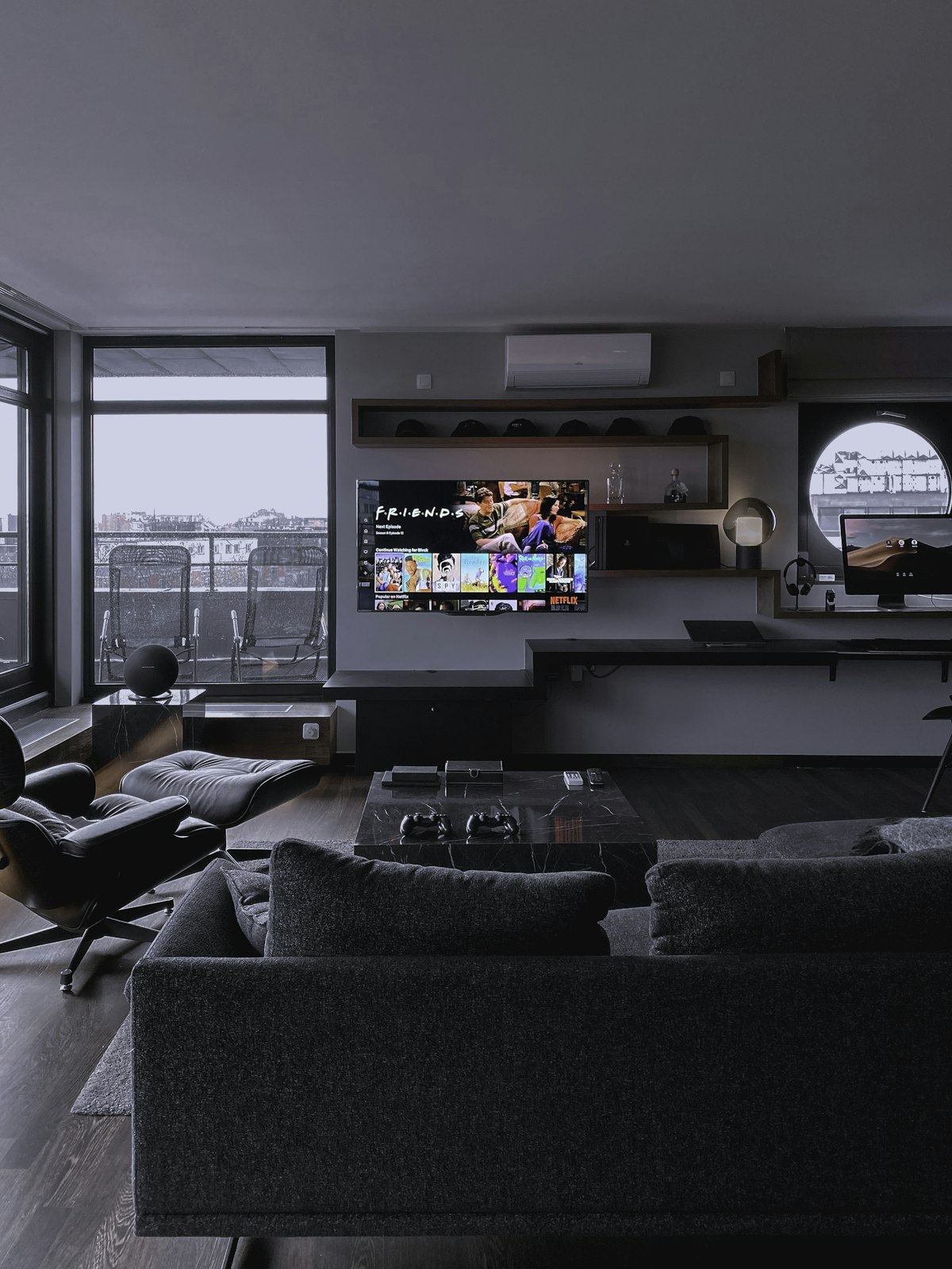 Modern living room with flat screen TV streaming content near large windows representing connected TV advertising