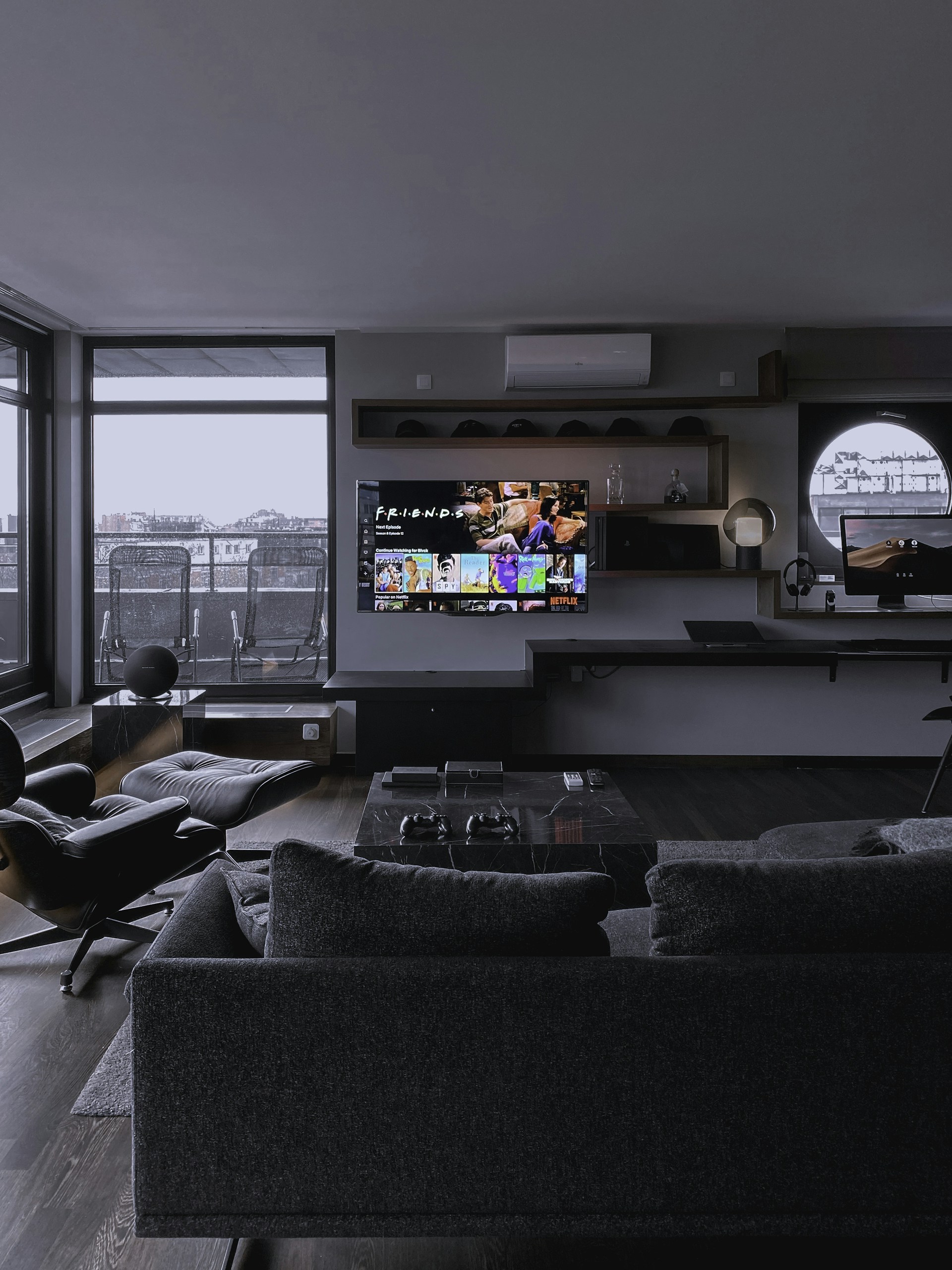 black flat screen tv turned on near window