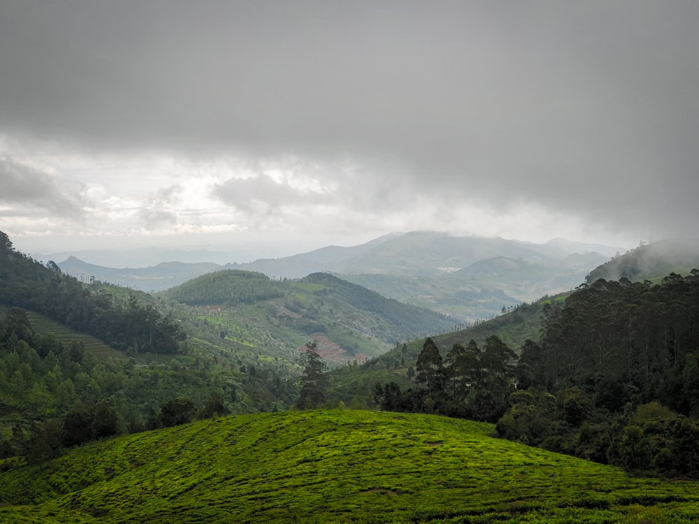 green mountains under white clouds during daytime