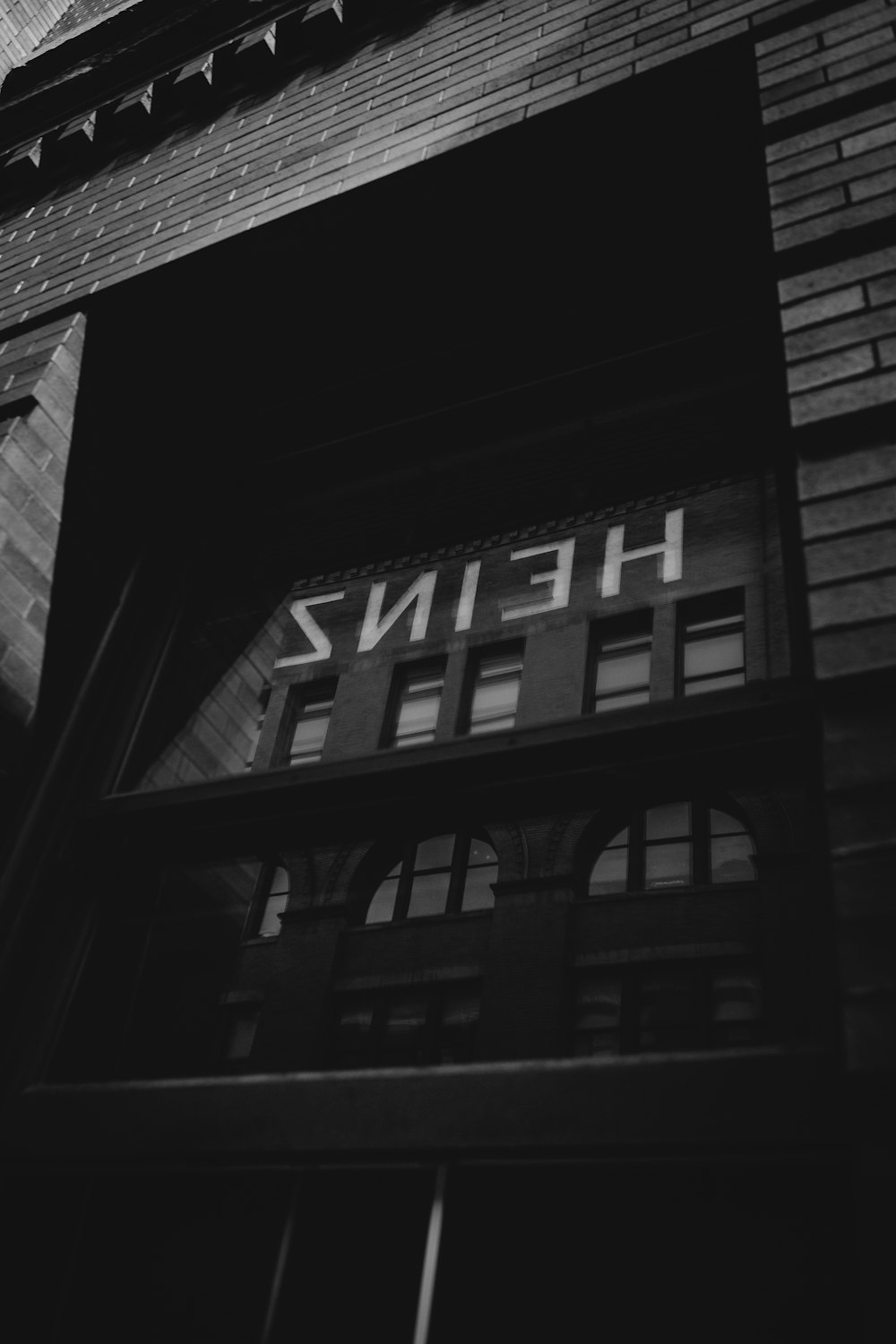 grayscale photo of building with glass windows