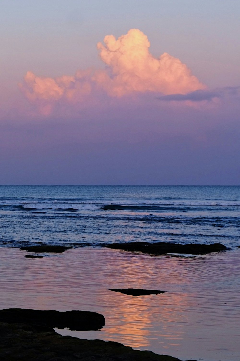 body of water under cloudy sky during daytime