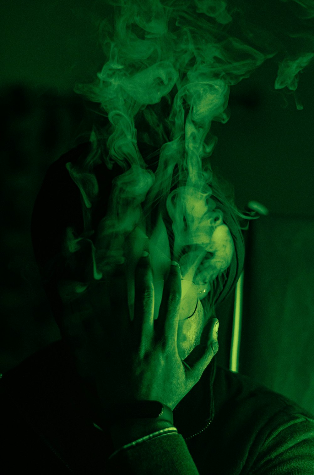 green smoke in dark room