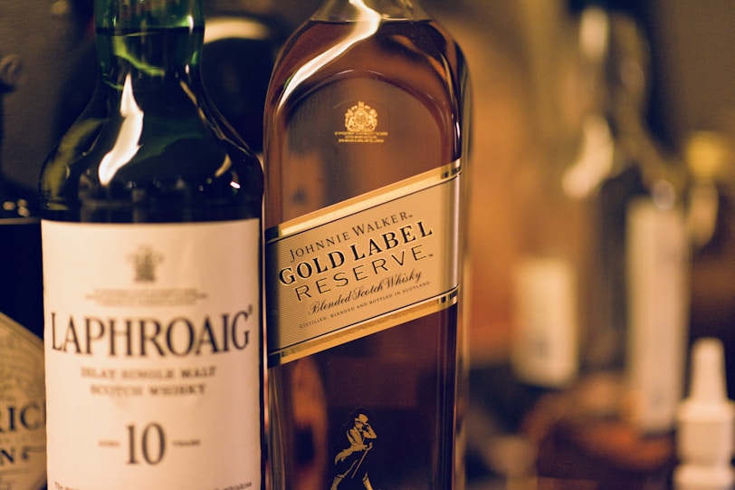 Scottish Whisky for Beginners a bottle of laphroaig and a bottle of  johnnie walker