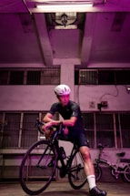 A cyclist filling out a contact form on a laptop in a bright, modern workspace.