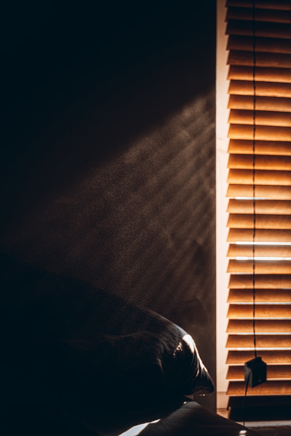 Fenster mit weißen Jalousien im Morgenlicht