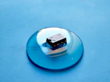 white and black cigarette pack on blue round plate