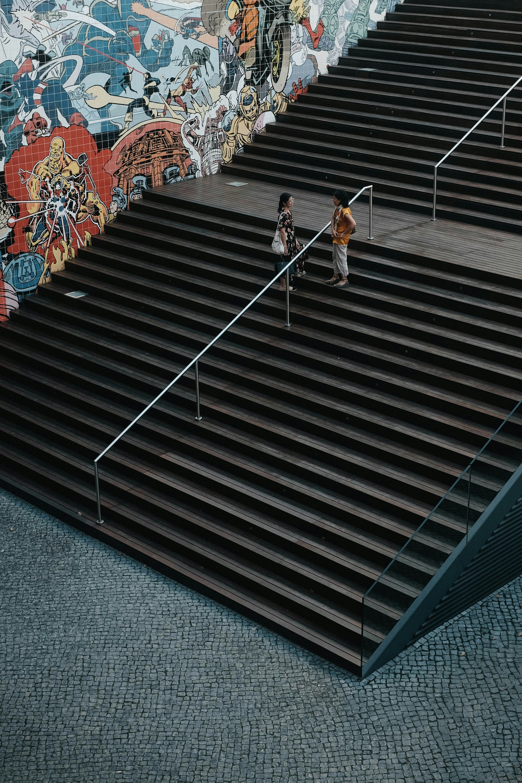 woman in white and orange dress walking on stairs