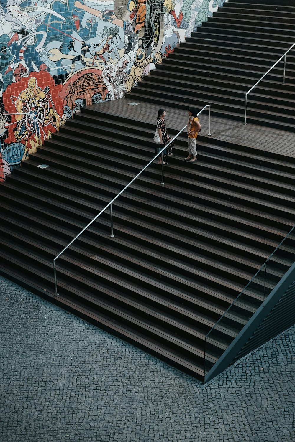 woman in white and orange dress walking on stairs