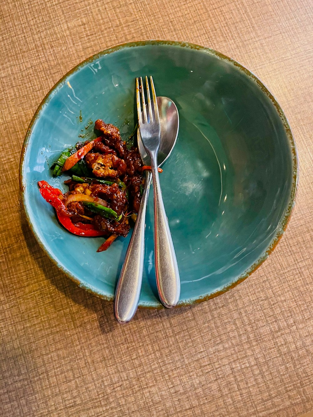 stainless steel fork and knife on blue ceramic plate