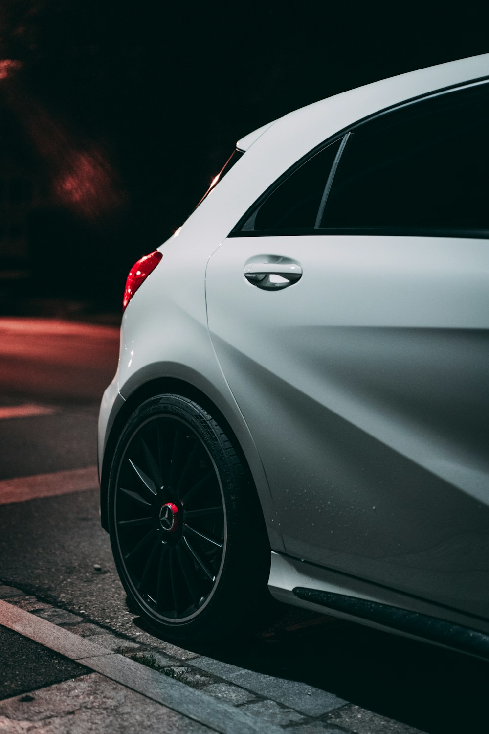 silver car on gray asphalt road during night time