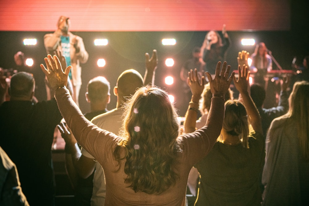 group of people raising their hands