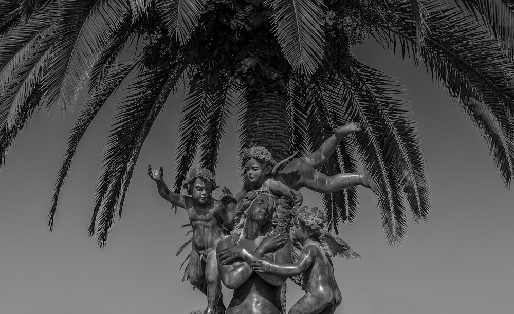 grayscale photo of statue of man and woman