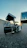 Photo of a man installing a video camera outside a home at sunset
