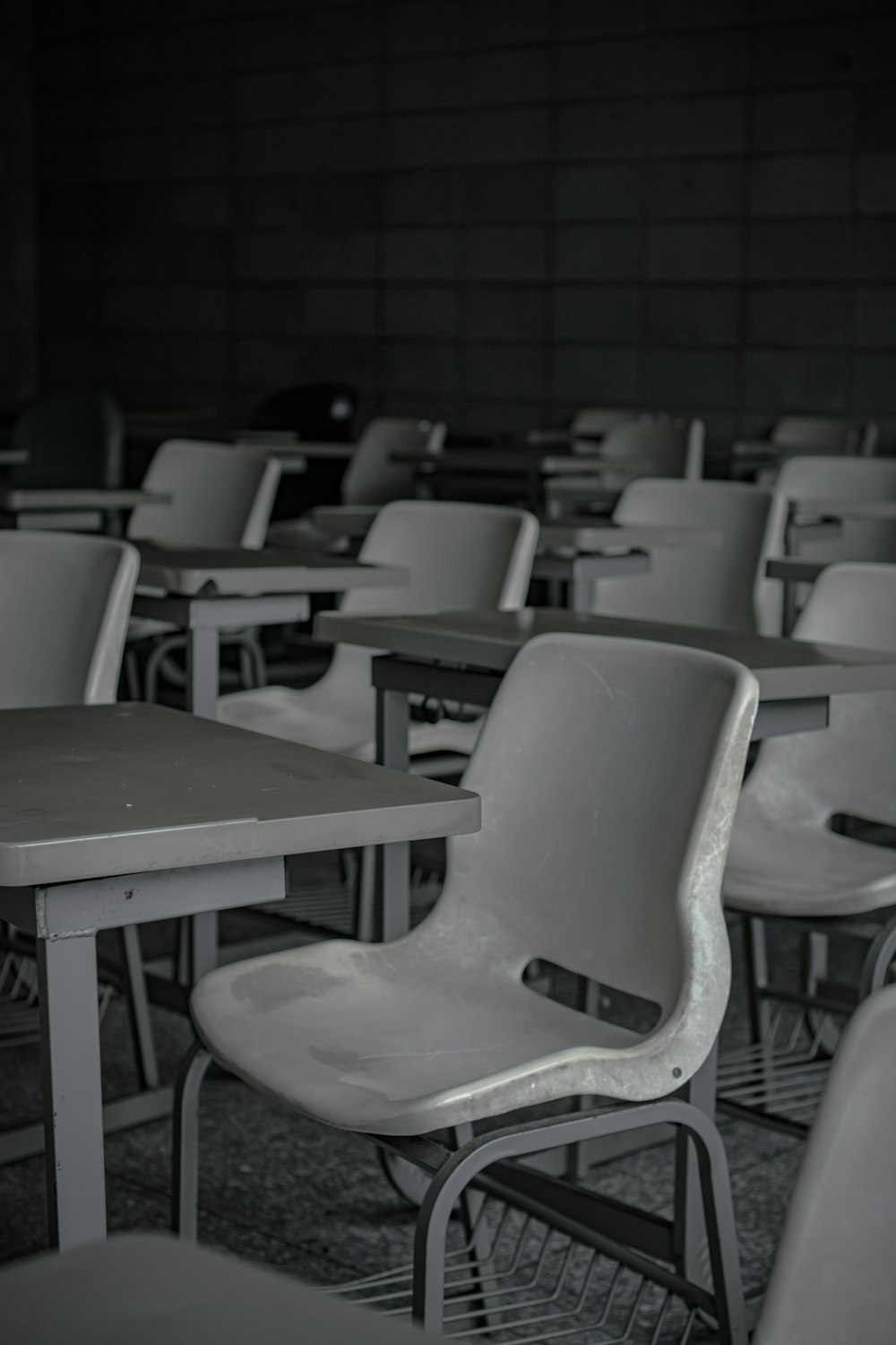 white plastic chairs in front of green table