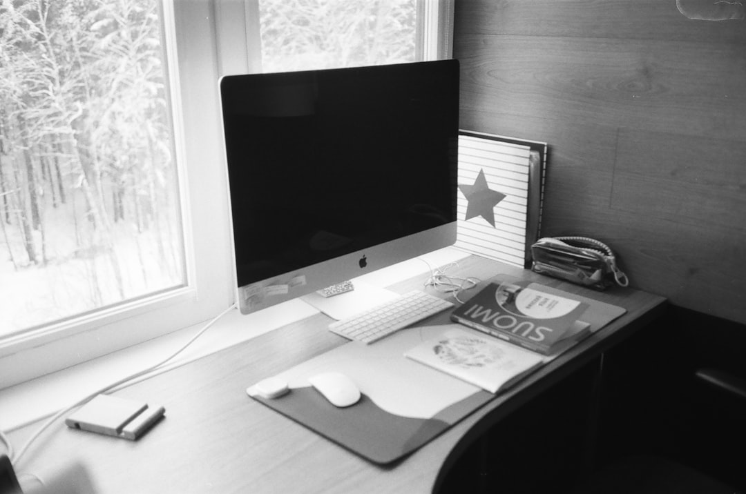 silver imac on black wooden table