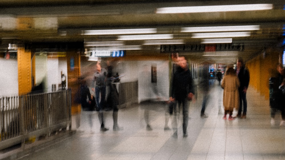 people walking on white floor tiles