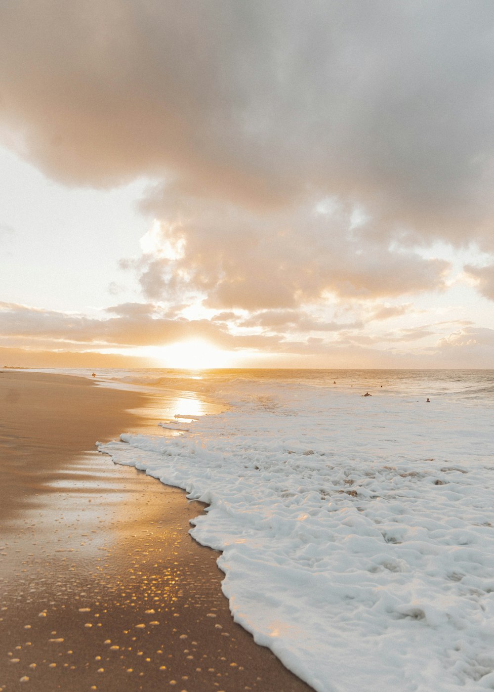 sea waves crashing on shore during sunset