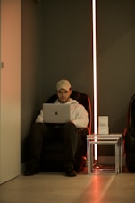 man in red long sleeve shirt using macbook