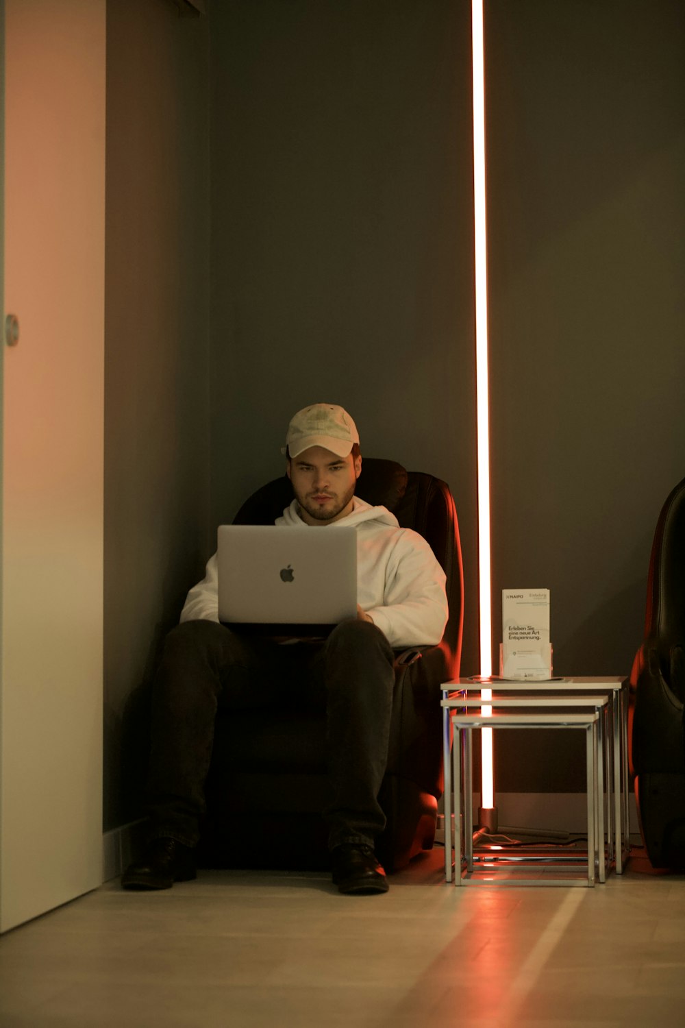 man in red long sleeve shirt using macbook