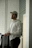 man in white dress shirt and black pants sitting on chair
