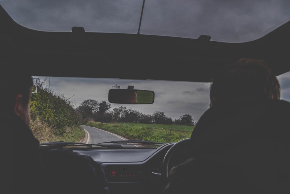 person in black jacket driving car during daytime