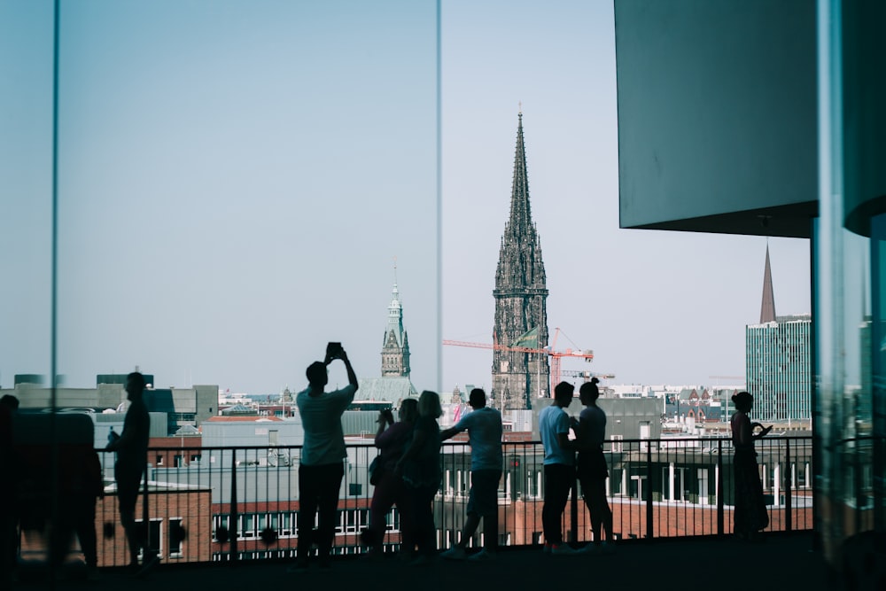 people standing on the roof of a building