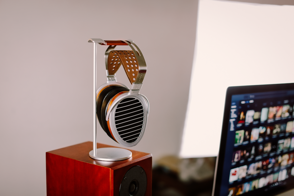 brown and silver speaker beside black flat screen computer monitor