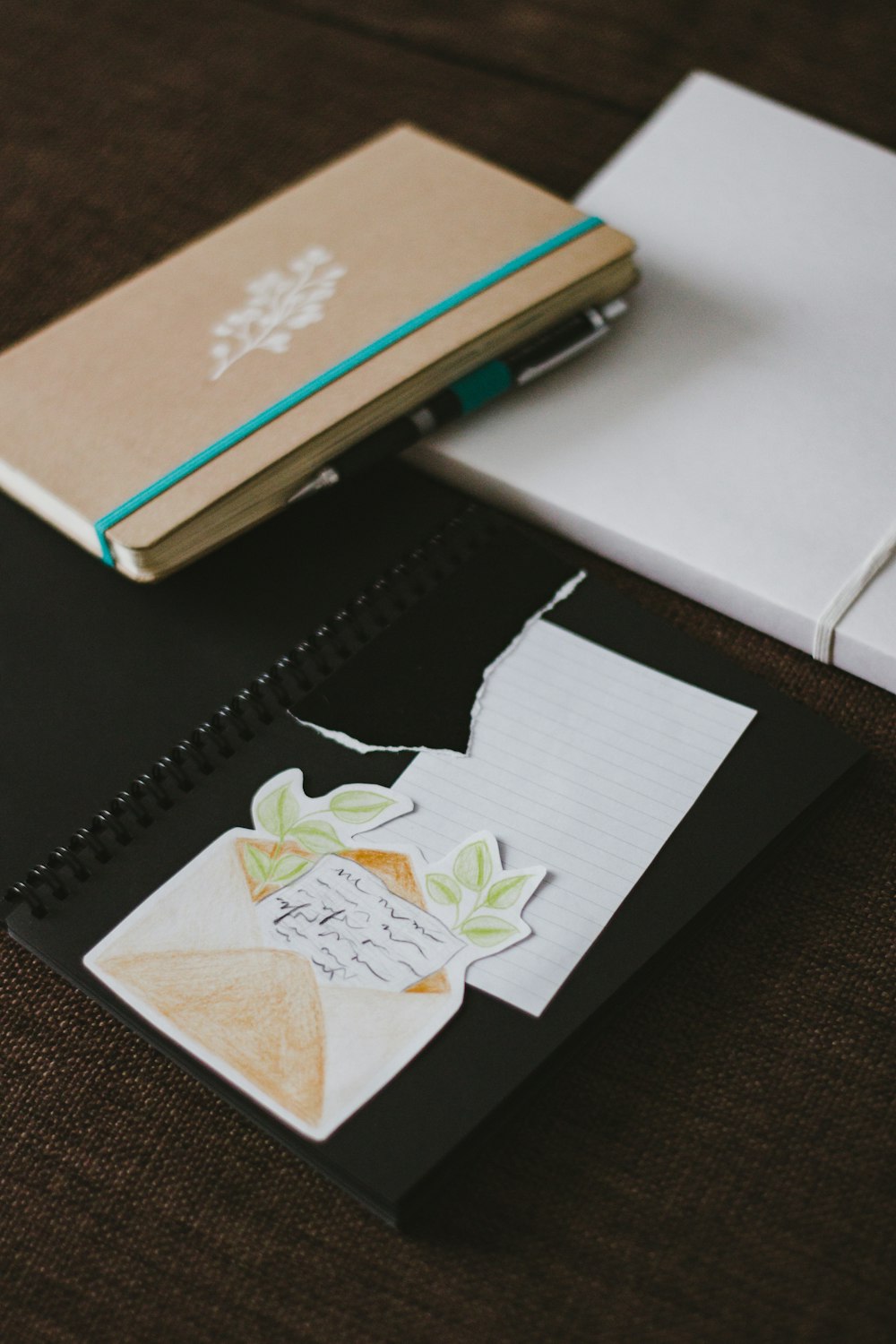 white and brown book on black leather case