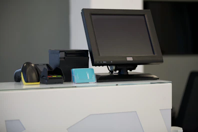 black flat screen computer monitor on white table