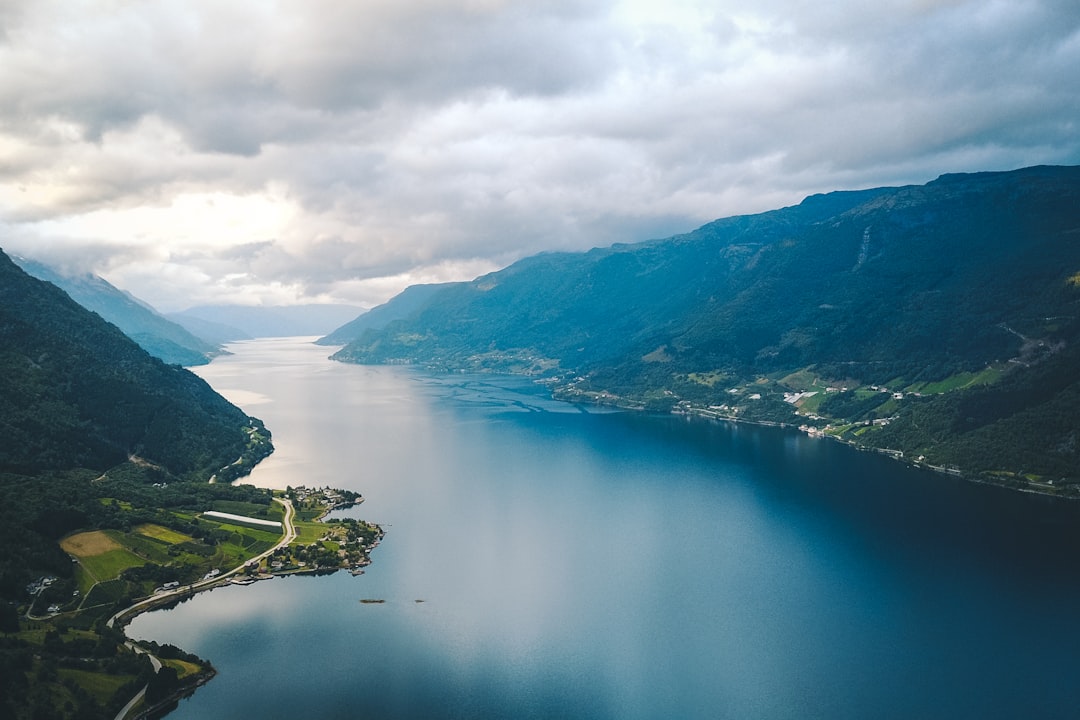 green mountains near body of water during daytime