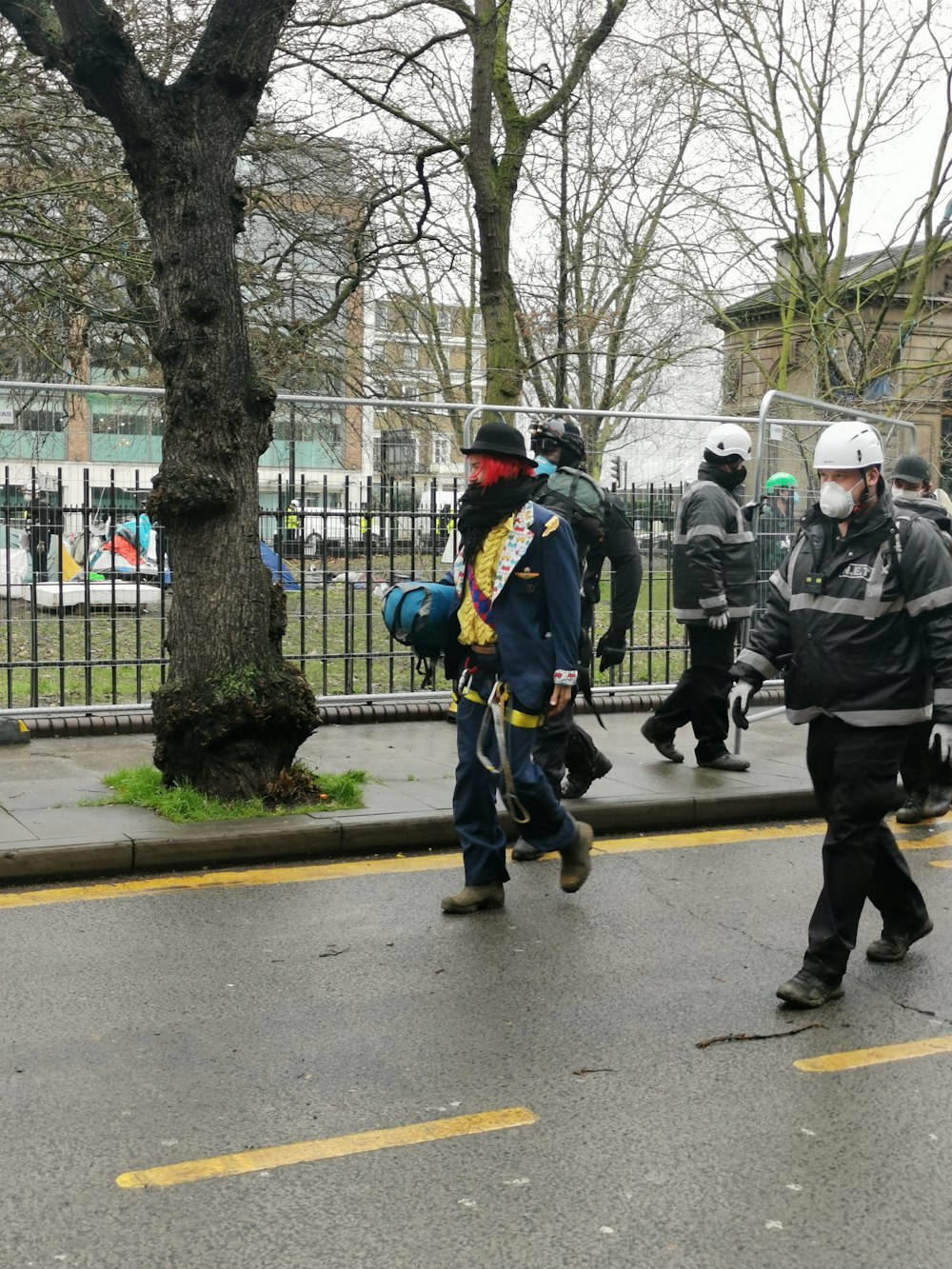 people in green jacket walking on pedestrian lane during daytime