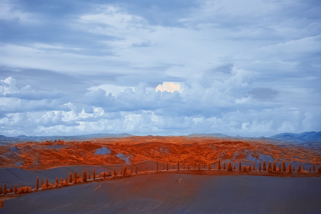 brown and white mountains under white clouds during daytime