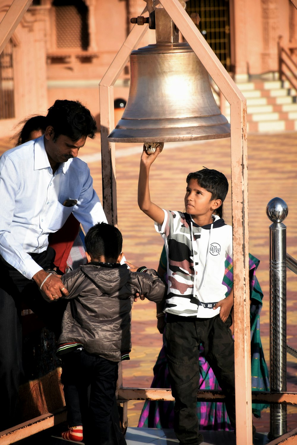 boy in white shirt and black pants standing beside boy in black shirt