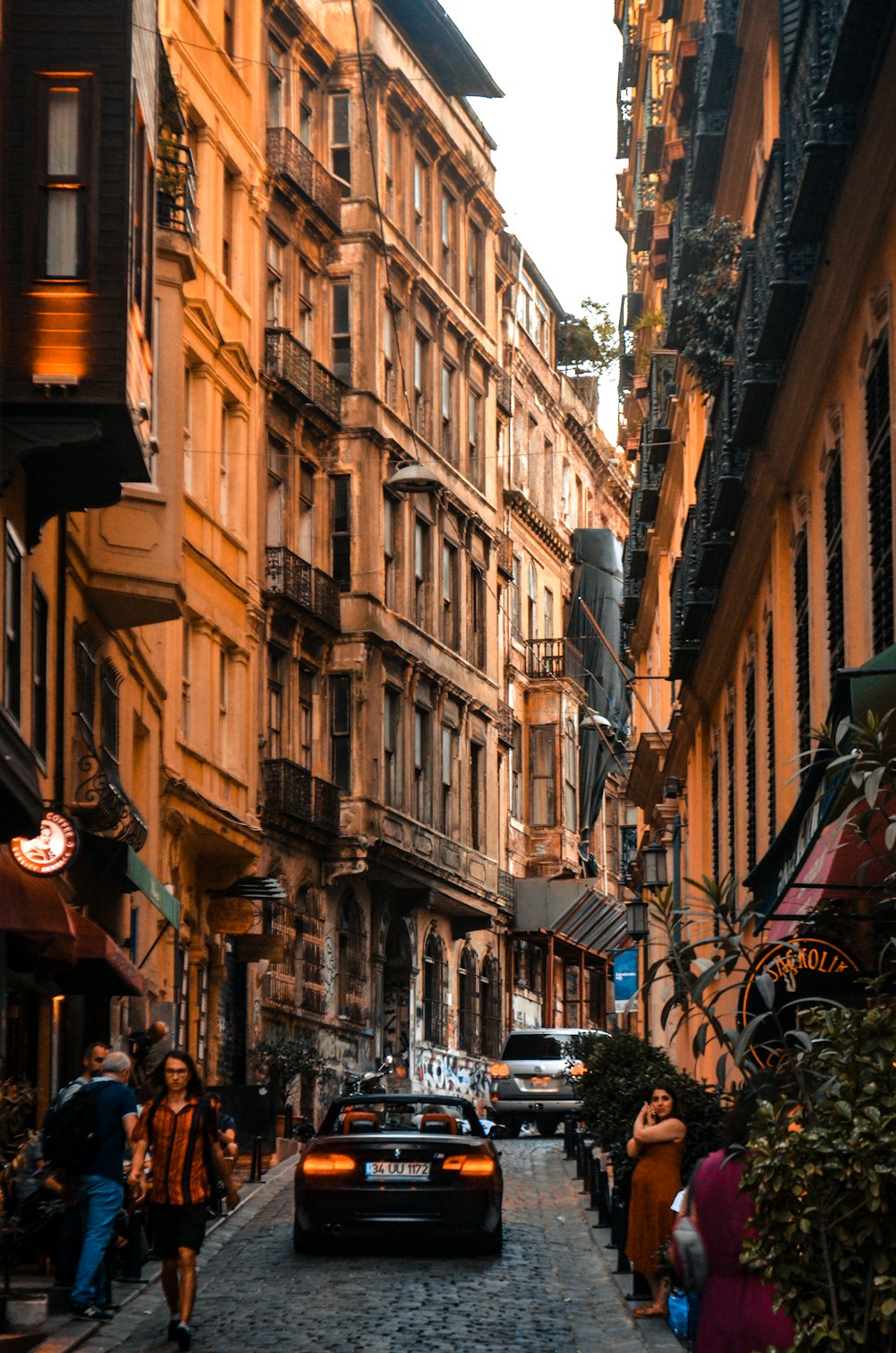 people walking on street between buildings during daytime