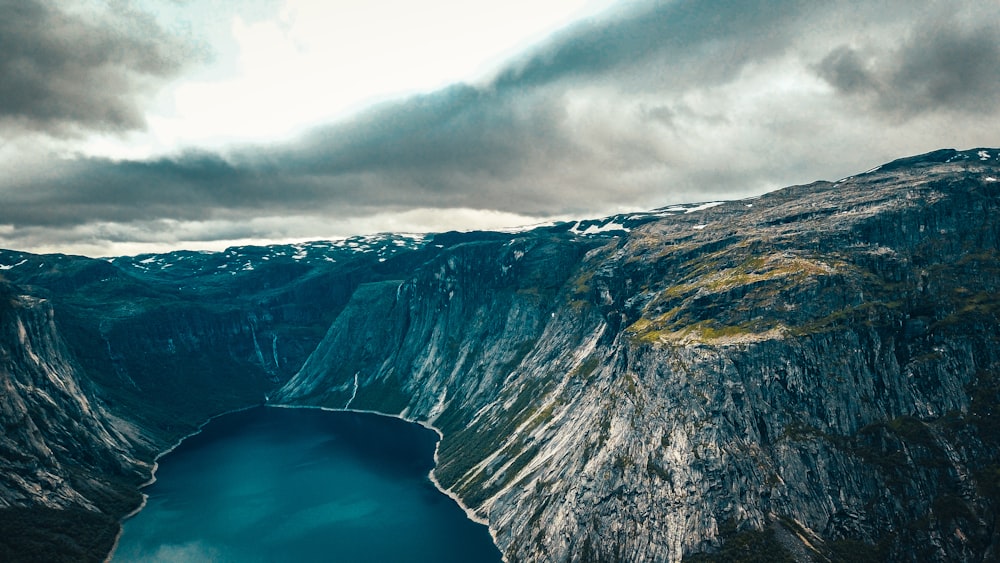 aerial view of mountain near body of water during daytime