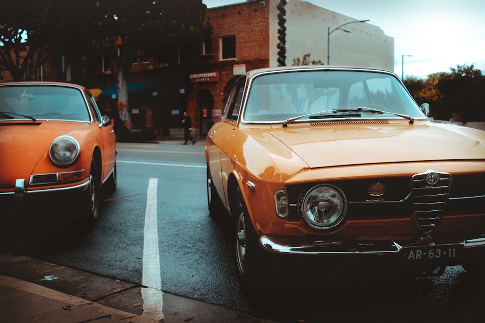 orange and white classic car on road during daytime