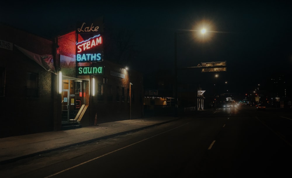 red and white UNKs store signage during night time