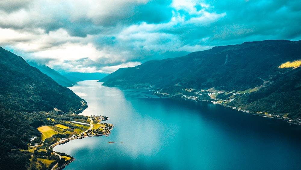 aerial view of green mountains and lake