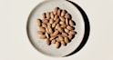 brown coffee beans on white ceramic bowl