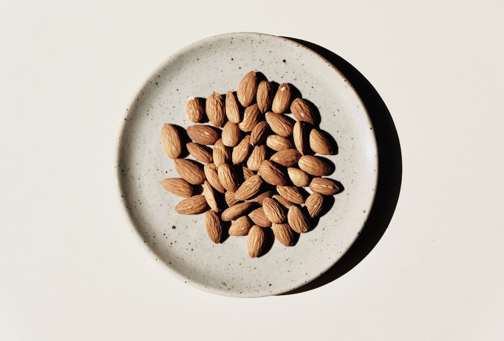 brown coffee beans on white ceramic bowl