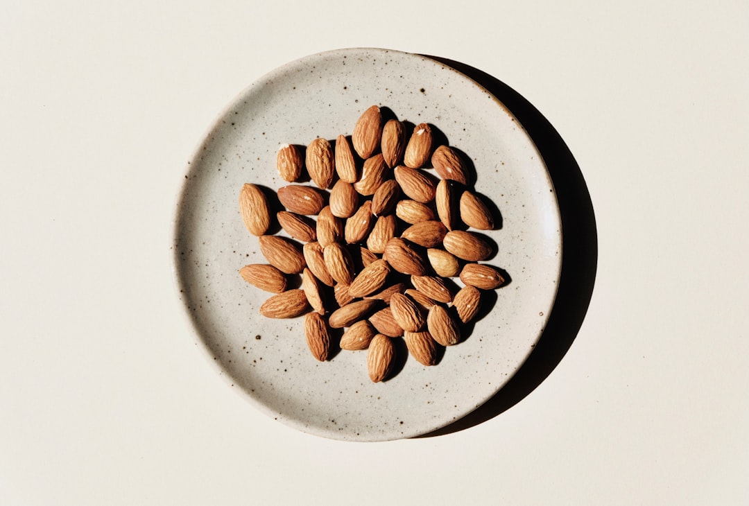 brown coffee beans on white ceramic bowl