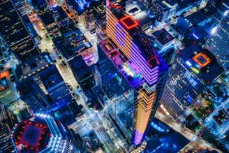 Aerial view of a vibrant city skyline highlighting popular short-term rental neighborhoods.
