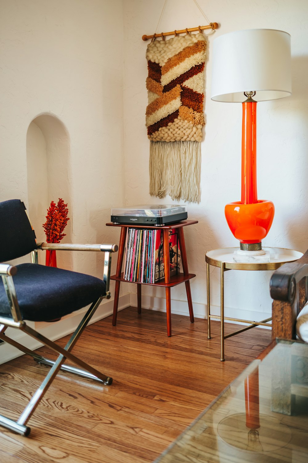 black and red padded chair beside brown wooden round table