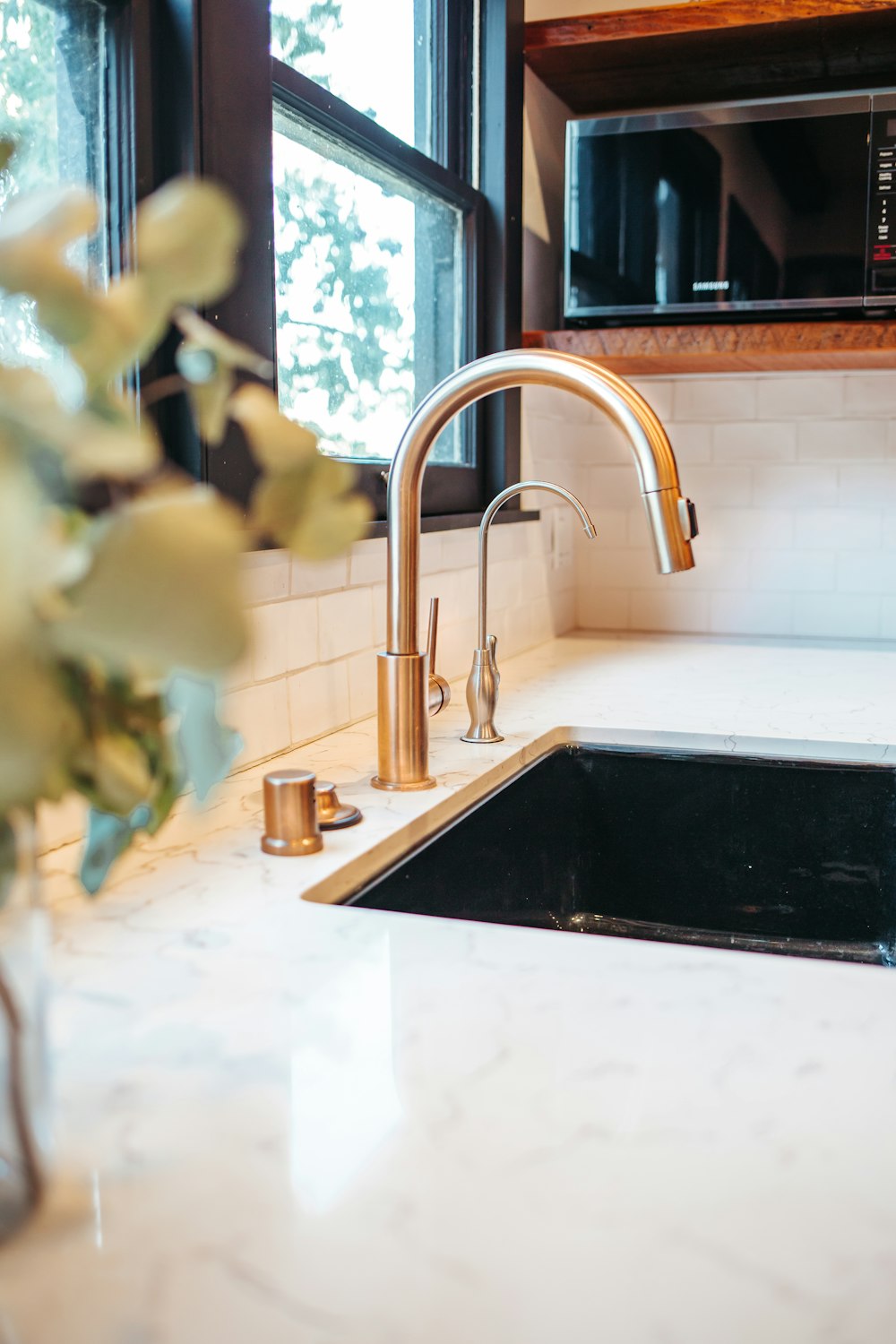 stainless steel faucet on white ceramic sink